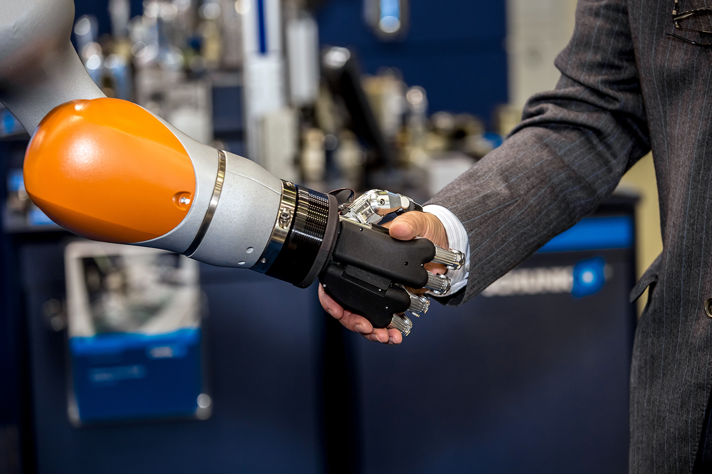 Robot hand shaking human hand